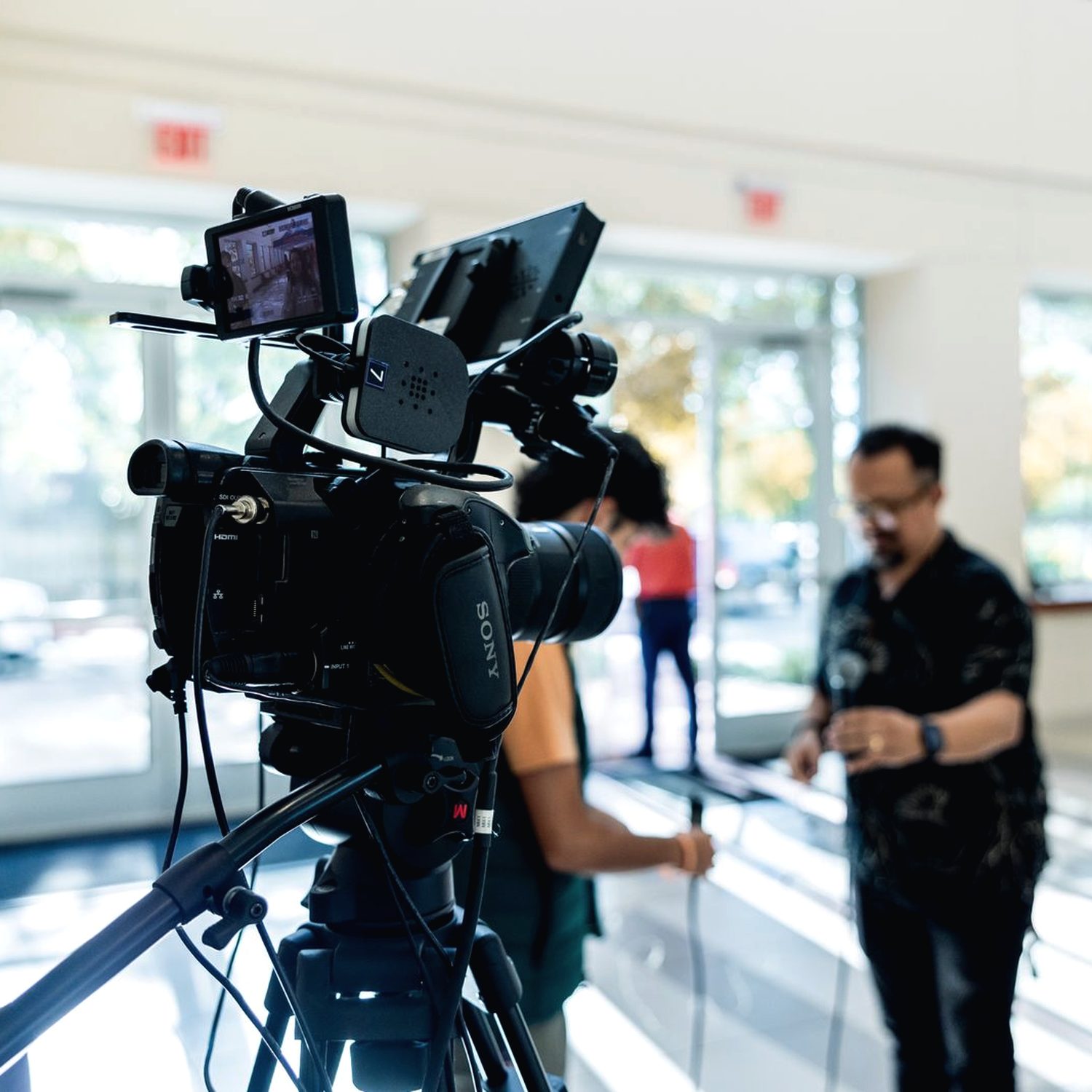 Warm-lit video production setup in a dim attorney office